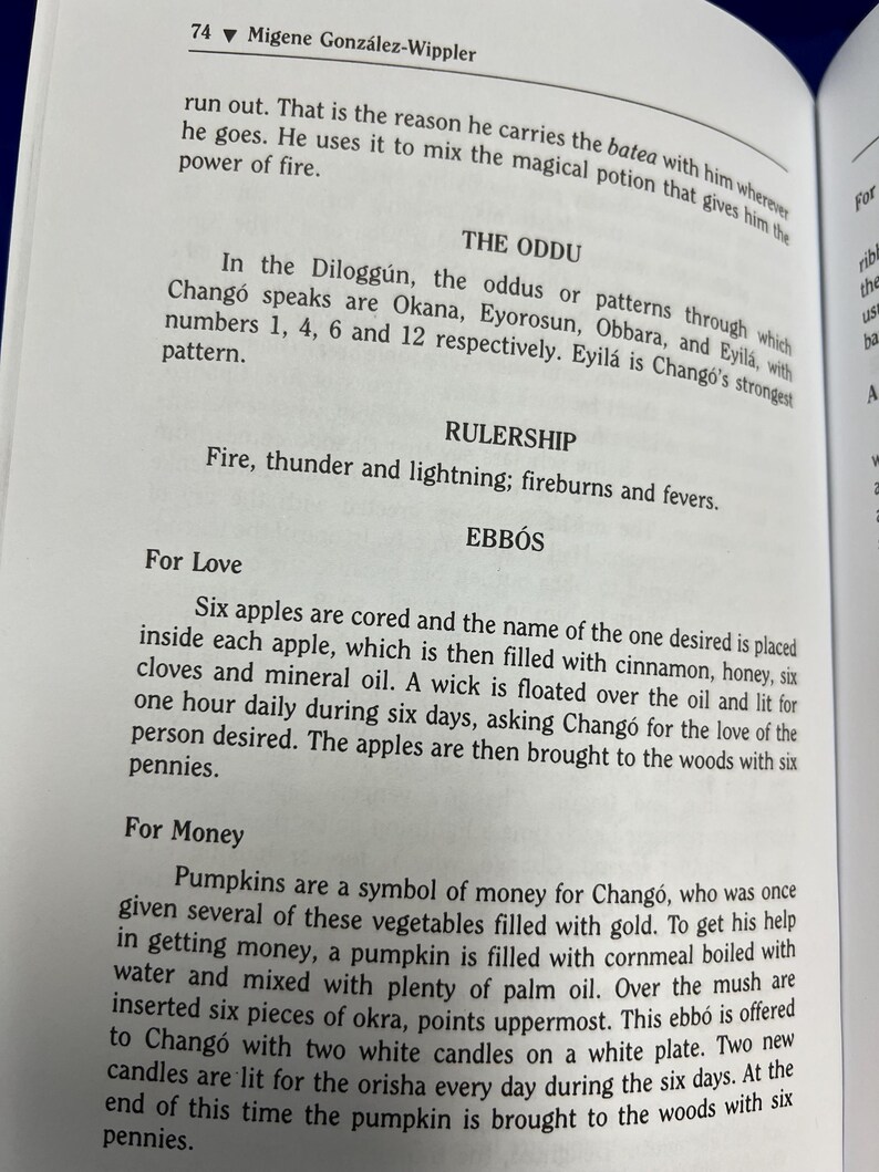 May include: Open book page with text about the Dilogg&uacute;n, oddus, and Chang&oacute;. The page includes instructions for rituals involving apples, cinnamon, honey, and pumpkins. The text is in black font.