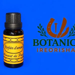 May include: A small dark amber glass bottle with a black ribbed cap and a yellow label featuring the text Payán d'amour and Aimant de Passion. To the right, a brown logo displays a horseshoe, a nail, and the text BOTANICA IREORISHAS.