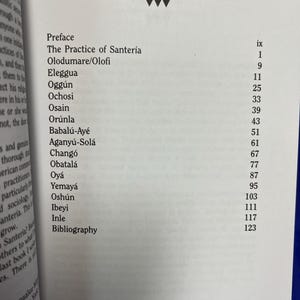May include: Open book page with the title "Contents" at the top. The page lists chapter titles such as "Preface", "The Practice of Santer&iacute;a", and "Eleggua", along with corresponding page numbers. The book is open to a white page.