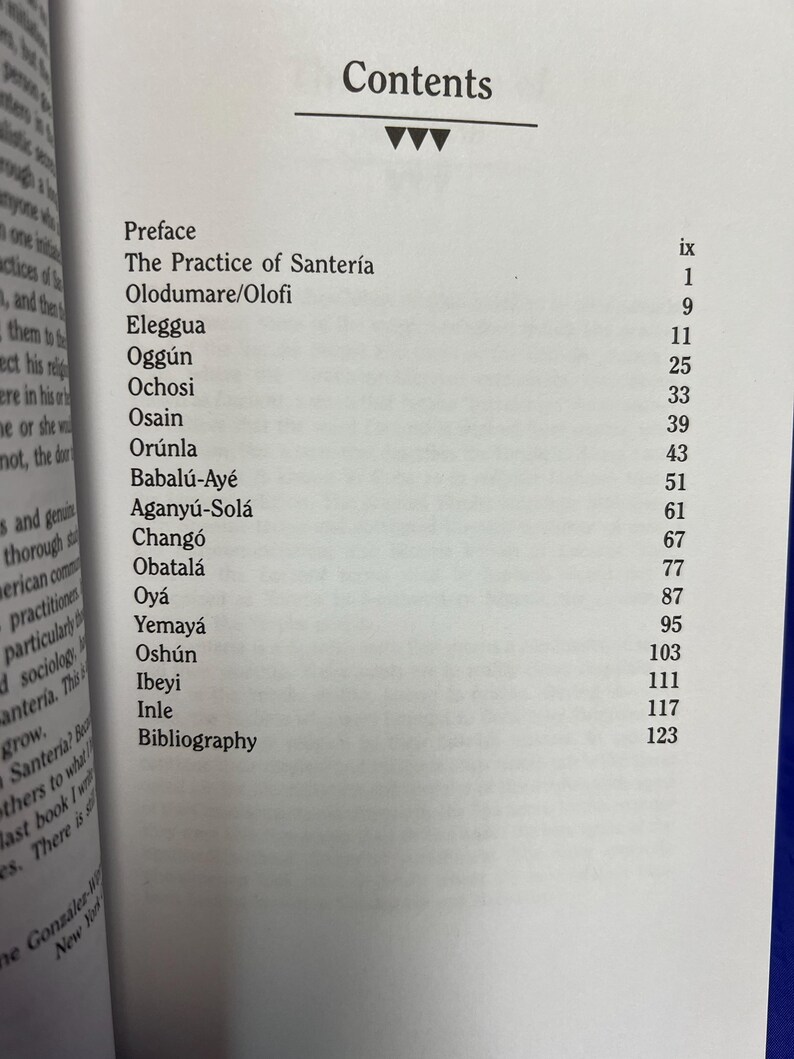 May include: Open book page with the title "Contents" at the top. The page lists chapter titles such as "Preface", "The Practice of Santer&iacute;a", and "Eleggua", along with corresponding page numbers. The book is open to a white page.