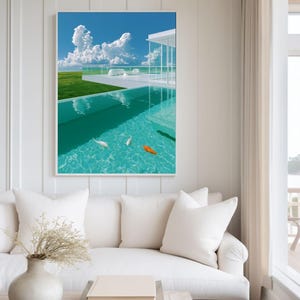 May include: A framed wall art print depicting a bright blue sky with white clouds over a modern white building with a glass balcony. Below, a clear turquoise swimming pool contains two white fish and one orange fish swimming in the water.