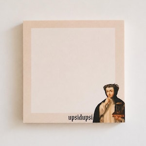 May include: Square notepad with a light beige border and a blank center. The lower right corner features a vintage illustration of a person in religious garb holding a small box. The word "upsidupsi" is printed in black.