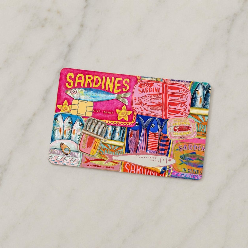 May include: A rectangular, colorful illustration featuring various sardine tins and fish imagery. The design incorporates pink, blue, yellow, and red hues, with the word "SARDINES" prominently displayed. The artwork has a vintage, hand-drawn aesthetic.