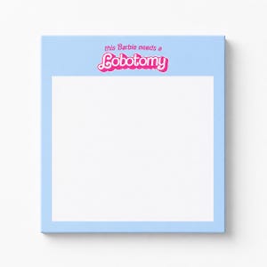 May include: A light blue square canvas with the text "this Barbie needs a Lobotomy" in pink and white. The canvas has a white center and a light blue border.