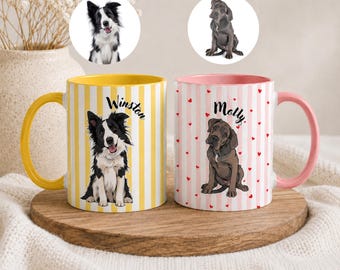 May include: Two ceramic mugs with dog illustrations. One mug is yellow with a black and white dog illustration and the name "Winston". The other mug is pink with a brown dog illustration and the name "Molly". Both mugs have vertical stripes.