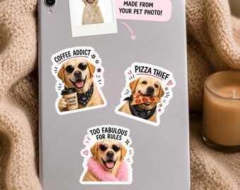 May include: A silver tablet featuring three custom stickers of a yellow Labrador retriever. One sticker shows the dog with sunglasses and a coffee cup labeled COFFEE ADDICT. Another shows the dog with pizza labeled PIZZA THIEF. The third shows the dog with pink heart glasses and a pink boa labeled TOO FABULOUS FOR RULES.