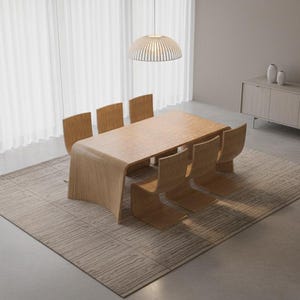 May include: A modern dining room set featuring a light wood table and six matching chairs. The table has a unique curved design. The set is placed on a patterned rug. A light fixture hangs above the table. A sideboard and decorative vases are in the background.