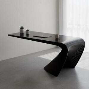 May include: A modern black desk with a unique curved design. The desk has a smooth, glossy surface and features a laptop, two small potted plants, and a mug. The desk is in a minimalist setting with a white wall and sheer curtains.