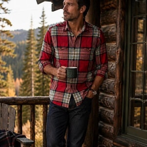 May include: A long-sleeve button-down shirt featuring a red, white, and green plaid pattern with two chest pockets, paired with dark blue denim jeans. The shirt has a classic collar and is worn with the sleeves rolled up to the mid-forearm.