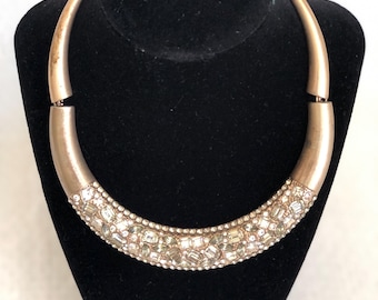 Choker style necklace with pale green and clear rhinestones.