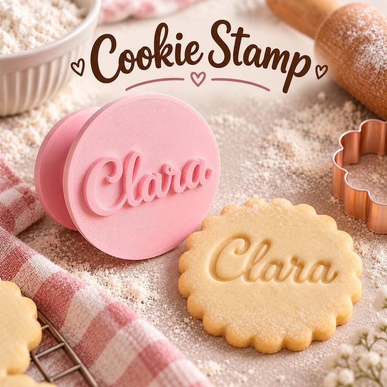 Pink round cookie stamp with the name Clara beside a cookie embossed with the same name