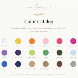 May include: A color catalog chart from Clair Design displaying twenty-four circular color swatches with labels including Matte White, White Silk, Yellow, Orange, Baby Pink, Hot Pink, Magenta Pink, Red, Terracotta, Purple, Dark Purple, Baby Green, Green, Dark Green, Baby Blue, Sky Blue, Turquoise Blue, Blue, Dark Blue, Matte Desert Brown, Matte Latte Brown, Dark Brown, Gray, and Matte Black.