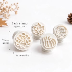 May include: Four white circular stamps featuring Thanksgiving designs including a turkey, a maple leaf, a pumpkin, and the text Give Thanks with a pumpkin. Each stamp measures 35 mm in height and 25 mm in width as indicated by the labels.
