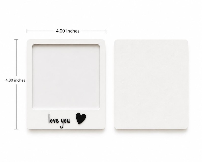 May include: Two white square frames, one with a cutout center and the text "love you" with a black heart icon. The frame measures 4.00 inches wide by 4.80 inches tall. The second piece is a solid white square backing plate for the frame.