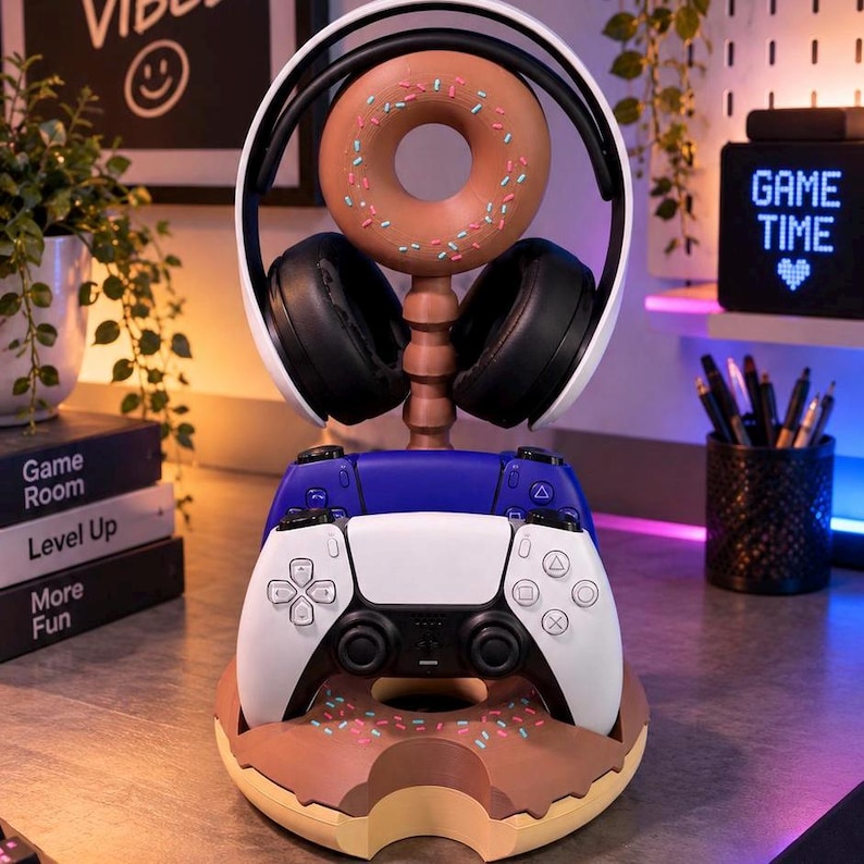Donut shaped gaming stand holding a headset on top and two game controllers below