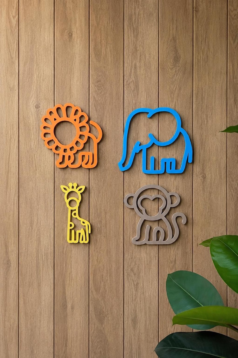 May include: Four colorful wooden animal cutouts: an orange lion, a blue elephant, a yellow giraffe, and a gray monkey. The animal shapes are mounted on a wooden wall, creating a playful and decorative theme.