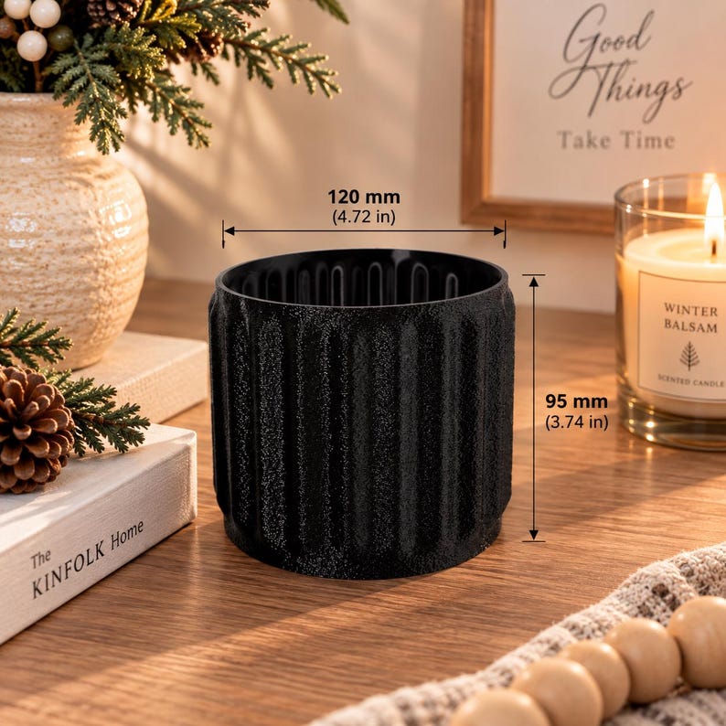 May include: A black cylindrical planter with a textured, vertically ribbed exterior. The planter measures 120 mm in diameter and 95 mm in height, as indicated by the measurement lines and text printed directly on the image.