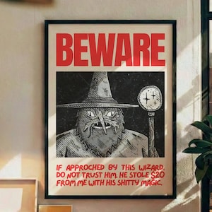 May include: A framed poster with the word "BEWARE" in red block letters. Below, a black and white illustration of a wizard with text that reads, "IF APPROACHED BY THIS WIZARD, DO NOT TRUST HIM. HE STOLE $20 FROM ME WITH HIS SHITTY MAGIC."