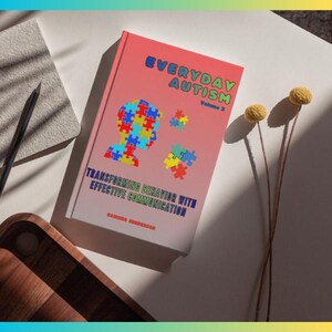 May include: A book titled "Everyday Autism Volume 2" with a red and pink cover. The cover features a puzzle piece design in the shape of a head and several other puzzle pieces. The text "Transforming Behavior with Effective Communication" is also visible.