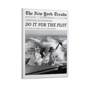 May include: Black and white framed print of a newspaper front page titled "The New York Trends." The headline reads "DO IT FOR THE PLOT." The image shows two people on a boat with a bottle of champagne.