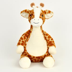 May include: A brown and tan plush giraffe toy with a white belly and a friendly face. The giraffe is sitting with its legs outstretched.
