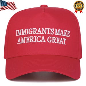 May include: A red baseball cap with the embroidered text "IMMIGRANTS MAKE AMERICA GREAT" in white. The cap features a curved brim and a button on top. An American flag and a "Best Seller" badge are in the background.