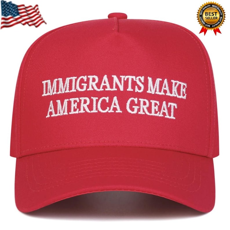 May include: A red baseball cap with the embroidered text "IMMIGRANTS MAKE AMERICA GREAT" in white. The cap features a curved brim and a button on top. An American flag and a "Best Seller" badge are in the background.