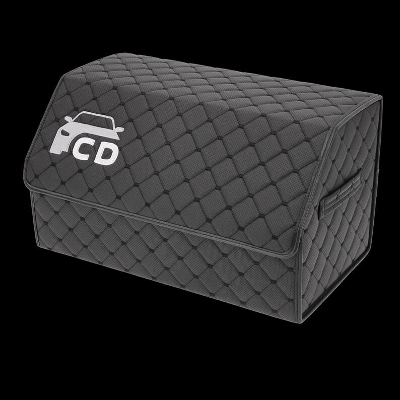 May include: A dark gray, quilted car trunk organizer with a white car logo and the letters "CD" on the front. The organizer has a handle on the side and a diamond pattern.