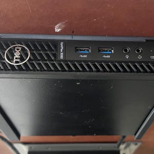 May include: A black Dell OptiPlex 3060 desktop computer. The front panel has the Dell logo, USB ports, audio jacks, and a power button. The top has a vent design.