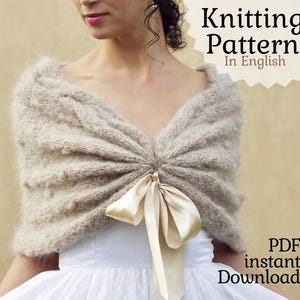 May include: Knitting pattern for a beige shawl with a satin ribbon tied in a bow at the center. The pattern is available as a PDF instant download and is written in English.