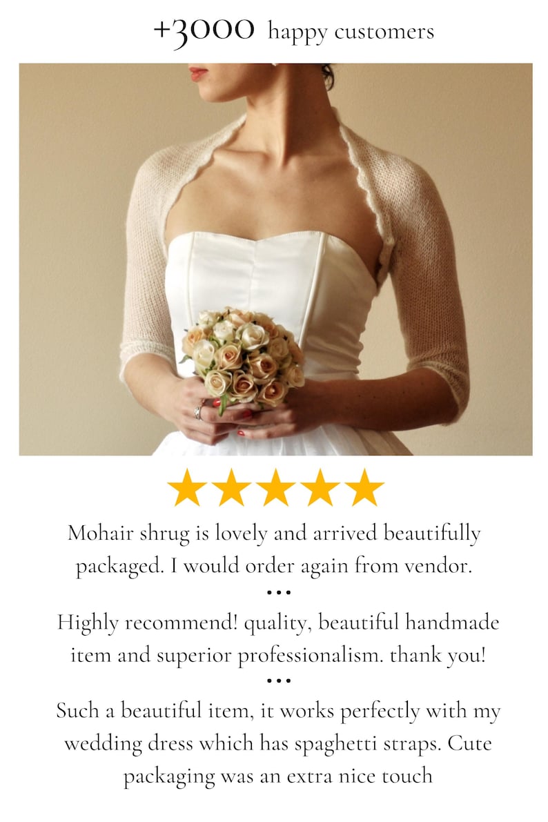 May include: A cream-colored, fine-knit mohair shrug with three-quarter length sleeves and a scalloped edge, worn over a strapless white dress. The image includes text stating +3000 happy customers and several five-star customer reviews.