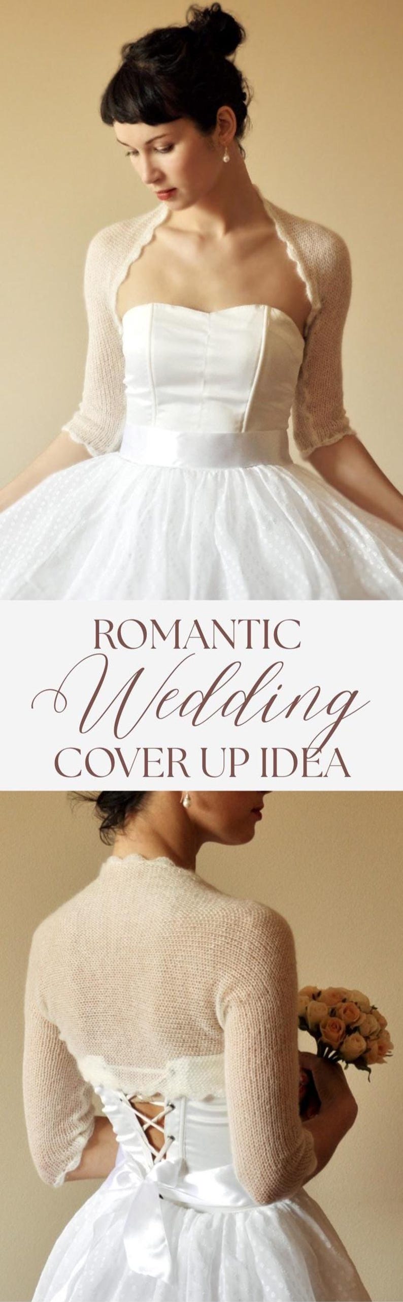 May include: A cream-colored, fine-knit bolero shrug with three-quarter length sleeves and a scalloped edge. The garment is worn over a white strapless dress featuring a satin waistband and a full skirt with a subtle dotted texture.