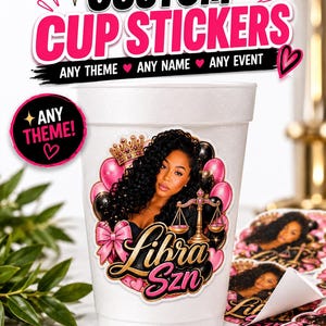 May include: A white foam cup featuring a custom sticker with a graphic of a person, a gold crown, pink and black balloons, a gold scale of justice, and a pink bow. The text on the sticker reads "Libra Szn". Additional stickers are visible nearby.