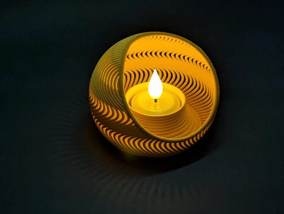Overhead close-up of a yellow TideNest holder with included flameless tea light