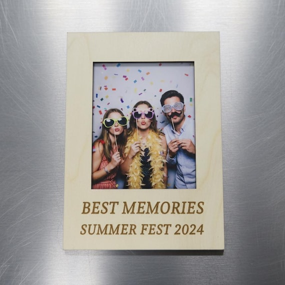 Engraved mini photo frame magnet holding a celebration snapshot, shown close up against a neutral background.