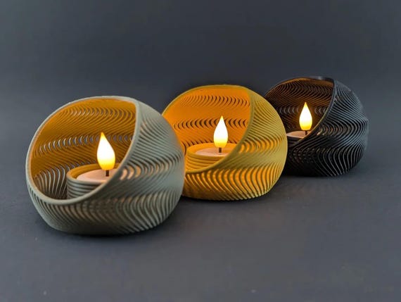 Angled close-up of three TideNest holders showing flowing wave ribs