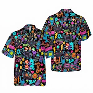 May include: Black button-up short-sleeve shirt with a vibrant all-over print featuring retro video game controllers, joysticks, pixelated hearts, mushrooms, and the text "GAME OVER". The shirt has a classic collar.