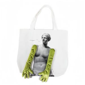 May include: White tote bag featuring a black and white image of a classical statue with green velvet gloves. The text "I'm good" is above the statue's head. The bag has white handles.