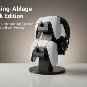 Könnte beinhalten: Schwarzer Gaming-Konsolenständer mit zwei weißen Controllern und einem schwarzen Headset. Der Ständer hat eine kreisförmige Basis und eine vertikale Stützstruktur. Der Text auf dem Bild lautet "Gaming-Ablage Black Edition".