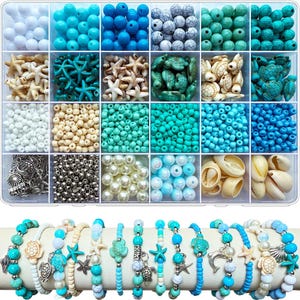 May include: A clear plastic storage container filled with twenty-four compartments of assorted beads, including blue, white, and turquoise spheres, starfish, and turtle shapes, alongside finished bracelets featuring charms of turtles, starfish, and seashells.