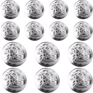 May include: A collection of twelve silver-colored buttons. Each button features a detailed heraldic crest design. The buttons are round with a slightly raised edge, and the crest is intricately embossed in the center.