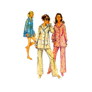 May include: Three women wearing pajamas. The woman on the left is wearing a light blue pajama top with a white collar. The woman in the middle is wearing a white pajama top with a white collar and matching pants. The woman on the right is wearing a pink pajama top with a white collar and matching pants with a floral print.