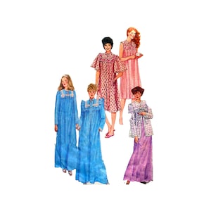 May include: Four women wearing different styles of nightgowns. The nightgowns are in various colors and patterns, including pink, blue, and white. The women are standing in a row, and each is holding a cup of coffee.
