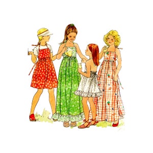 May include: Four girls wearing different floral print dresses. The girls are standing together and smiling. The dresses are all different colors and patterns.