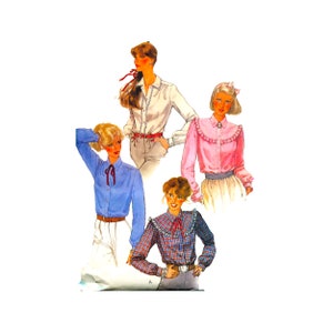 May include: Four women's blouses with different styles and colors. The blouses have long sleeves and ruffled collars. One blouse is white, one is pink, one is blue, and one is plaid.