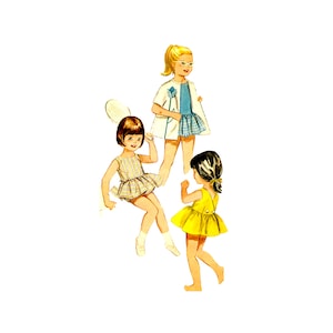 May include: Three girls playing together. One girl is wearing a blue and white dress and a white cardigan. Another girl is wearing a yellow dress. The third girl is wearing a striped dress and holding a tennis racket.