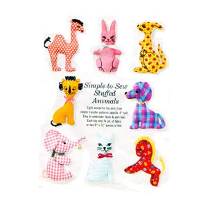 May include: A collection of eight handmade stuffed animal toys, each approximately 9 inches tall, in various colors and patterns. The toys include a camel, rabbit, kangaroo, lion, dog, elephant, cat, and horse. The text "Simple-to-Sew Stuffed Animals" is also visible.