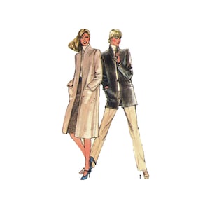 May include: Two women wearing long coats. The woman on the left is wearing a beige coat with a high collar and the woman on the right is wearing a dark brown coat with a high collar. Both women are wearing pants and heels.