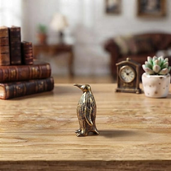 A tiny hand-cast brass penguin sculpted as a traditional Chinese 'tea pet' — tactile, desk-worthy, and genuinely artisan-made.