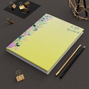 Könnte beinhalten: Eine weiße Keramik-Tasse mit schwarzem Henkel und dem Text "But First, Coffee" in fetter, schwarzer Schrift. Die Tasse steht vor einem verschwommenen Hintergrund, der eine gemütliche Umgebung suggeriert.